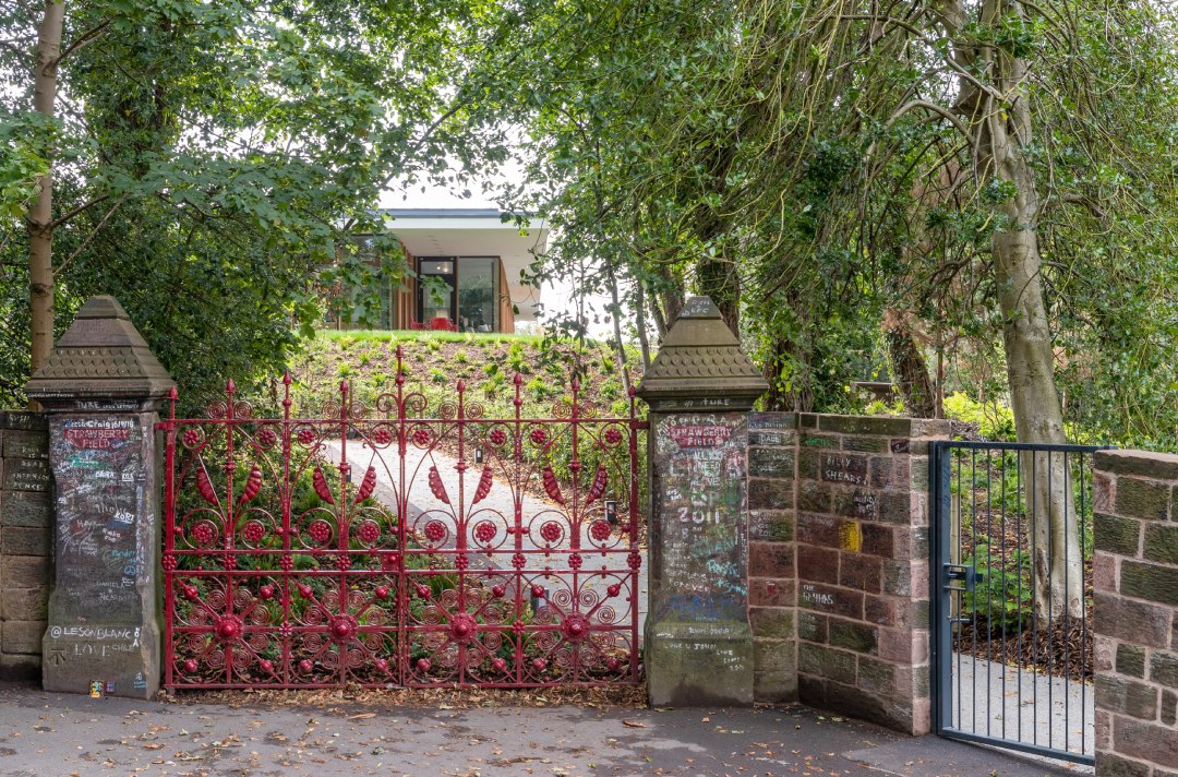 The famous red gates John Lennon stepped through leading to the visitor centre at Strawberry Field