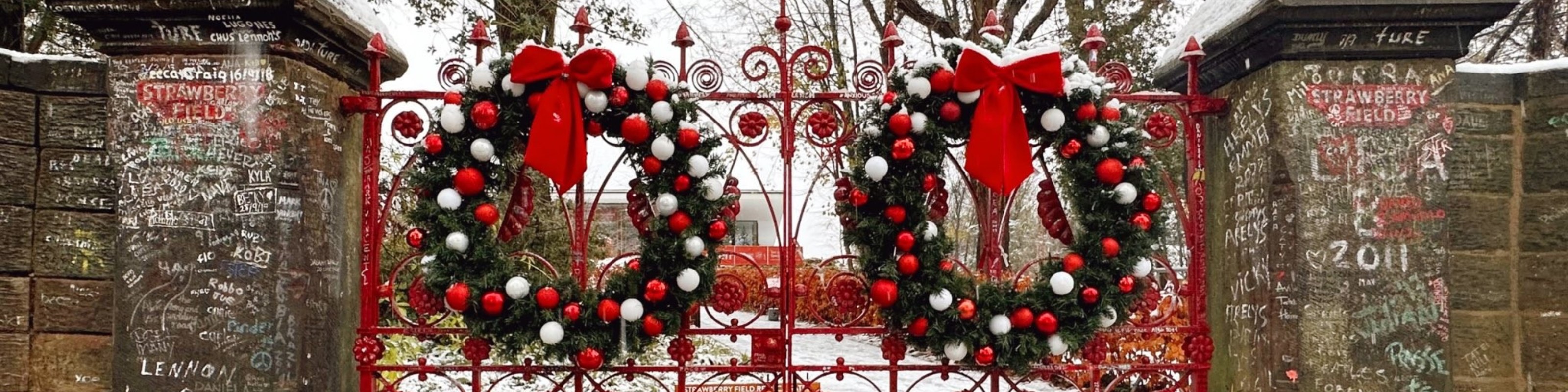 festive wreaths hanging on the famous red gates at Strawberry Field