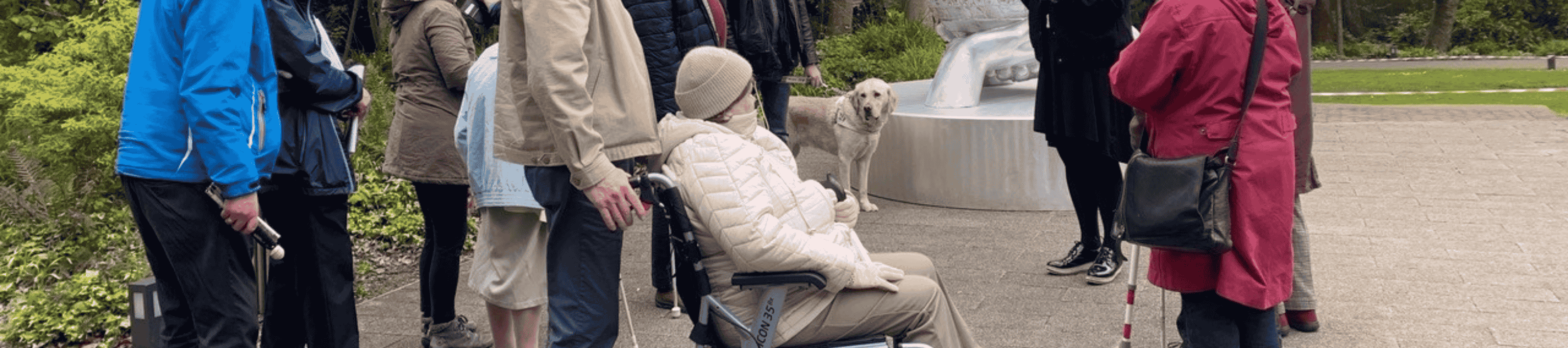 A woman in a wheel chair and a guide dog